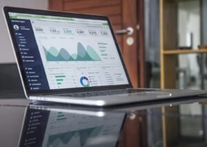 Laptop displaying website analytics and design workspace representing website design and web development